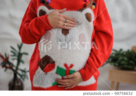 Beautiful pregnant woman holding her hands on her belly Beautiful pregnant woman holding her hands on her belly 99756632