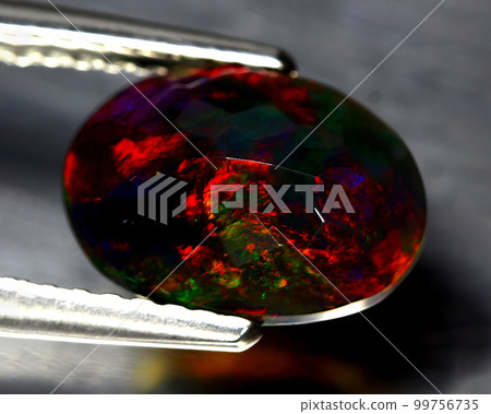 Natural beautiful gemstone opal on gray background 99756735