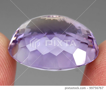 Natural gemstone bi color ametrine on gray background 99756767