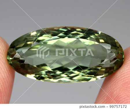 Natural stone green amethyst on a gray background 99757172