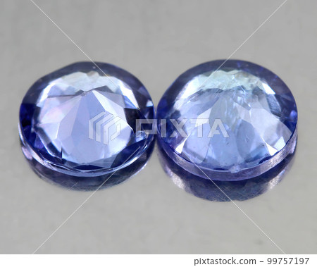 Beautiful natural tanzanite gemstone on gray background Beautiful natural tanzanite gemstone on gray background 99757197
