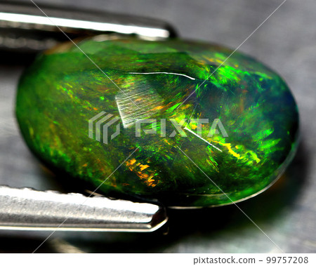 Natural beautiful gemstone opal on gray background 99757208