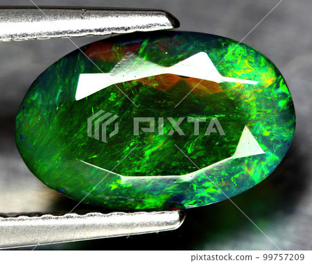 Natural beautiful gemstone opal on gray background 99757209