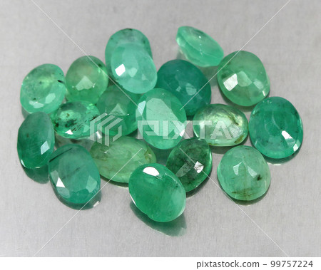 Natural gemstone green emerald on a gray background 99757224