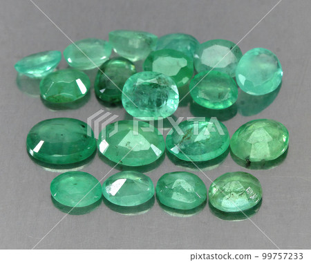 Natural gemstone green emerald on a gray background 99757233