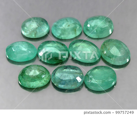 Natural gemstone green emerald on a gray background 99757249