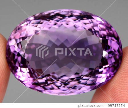 Natural gemstone purple amethyst on gray background Natural gemstone purple amethyst on gray background 99757254