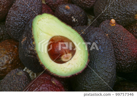 Stack of avocados on a market stall 99757346