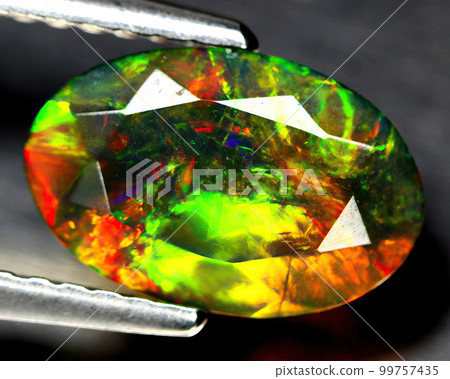 Natural beautiful gemstone opal on gray background Natural beautiful gemstone opal on gray background 99757435