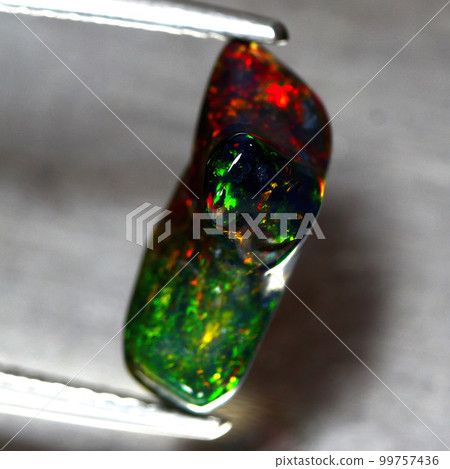 Natural beautiful gemstone opal on gray background 99757436