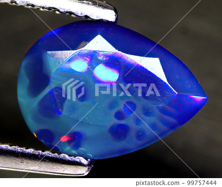 Natural beautiful gemstone opal on gray background 99757444