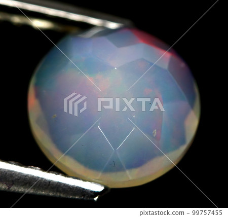 Natural beautiful gemstone opal on gray background Natural beautiful gemstone opal on gray background 99757455