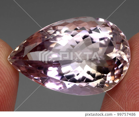 Natural gemstone bi color ametrine on gray background 99757486