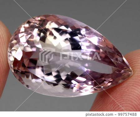 Natural gemstone bi color ametrine on gray background 99757488
