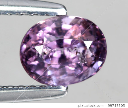 Natural stone purple amethyst on a gray background 99757505