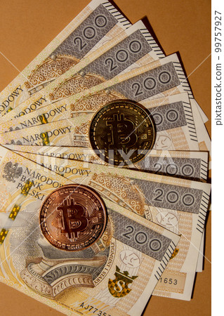 Bitcoin gold coin on bills of 200 polish zloty currency. Bitcoin mining trading concept. BTC golden money spinning around. Worldwide virtual internet Cryptocurrency or crypto digital payment system Bitcoin gold coin on bills of 200 polish zloty currency. Bitcoin mining trading concept. BTC golden money spinning around. Worldwide virtual internet Cryptocurrency or crypto digital payment system 99757927