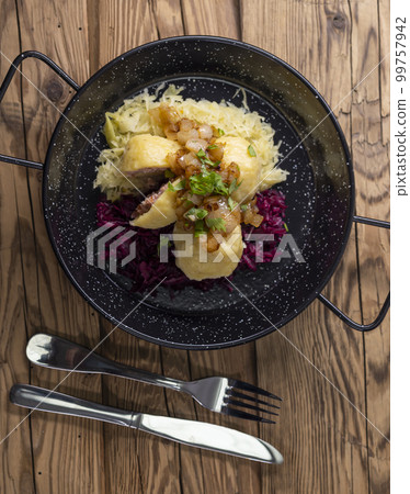 dumpllings filled with smoked meat served with red and white cabbage dumpllings filled with smoked meat served with red and white cabbage 99757942