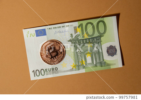 Bitcoin gold coin on bills of 100 euros eu currency. Bitcoin mining trading concept. BTC golden money spinning around. Worldwide virtual internet Cryptocurrency or crypto digital payment system Bitcoin gold coin on bills of 100 euros eu currency. Bitcoin mining trading concept. BTC golden money spinning around. Worldwide virtual internet Cryptocurrency or crypto digital payment system 99757981