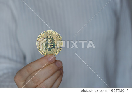 Female hands holding Bitcoin gold coin. Bitcoin mining trading concept. BTC golden money spinning around. Worldwide virtual internet Cryptocurrency or crypto digital payment system Female hands holding Bitcoin gold coin. Bitcoin mining trading concept. BTC golden money spinning around. Worldwide virtual internet Cryptocurrency or crypto digital payment system 99758045