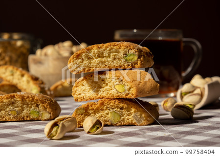 Biscotti Cantuccini Cookie Biscuits with pistachios and lemon peel Shortbread. Healthy eating food. Homemade fresh Italian cookies cantucci stacks and organic pistachios nuts. Vegan dieting 99758404