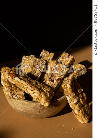 Homemade Granola energy bar. Variety of homemade protein granola breakfast bars with nuts, raisins dried cherries and chocolate. Healthy nutrition eating Gluten free cereal dieting snack super food Homemade Granola energy bar. Variety of homemade protein granola breakfast bars with nuts, raisins dried cherries and chocolate. Healthy nutrition eating Gluten free cereal dieting snack super food 99758411