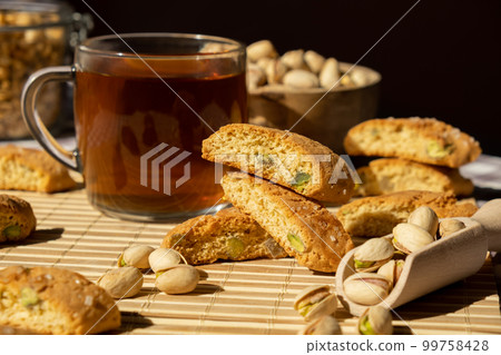 Biscotti Cantuccini Cookie Biscuits with pistachios and lemon peel Shortbread. Cup of tea. Teatime break Healthy eating food. Homemade fresh Italian cookies cantucci stacks and organic pistachios nuts 99758428