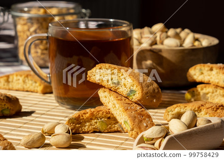Biscotti Cantuccini Cookie Biscuits with pistachios and lemon peel Shortbread. Cup of tea. Teatime break Healthy eating food. Homemade fresh Italian cookies cantucci stacks and organic pistachios nuts Biscotti Cantuccini Cookie Biscuits with pistachios and lemon peel Shortbread. Cup of tea. Teatime break Healthy eating food. Homemade fresh Italian cookies cantucci stacks and organic pistachios nuts 99758429