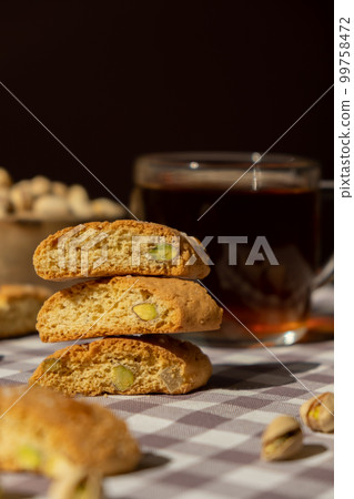 Biscotti Cantuccini Cookie Biscuits with pistachios and lemon peel Shortbread. Cup of tea. Teatime break Healthy eating food. Homemade fresh Italian cookies cantucci stacks and organic pistachios nuts 99758472