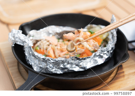 Camping rice with foil grilled salmon made in a skillet 99758897