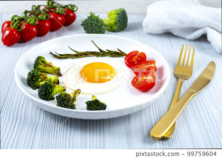 Fried soft-boiled egg on a white plate Fried soft-boiled egg on a white plate 99759604