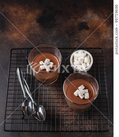chocolate dessert panna cotta in portioned cups. dark background, side view 99759686