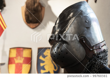 Medieval knight armor, closed iron helmet close up 99760381