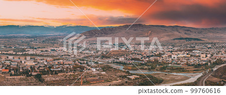 Gori, Shida Kartli Region, Georgia. Panorama Of Gori Cityscape In Evening Time. Aerial Panoramic View Of City. Travel Destination. Amazing Bright Dusk Sky 99760616