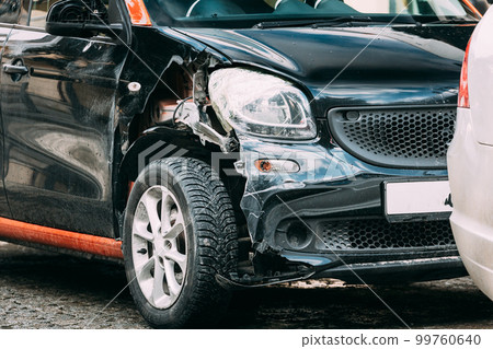 Broken Scratched And Dent Bumper Fender Car after Collision. Scratched With Deep Damage To Paint. Crashed car parked on City Street. Car Wreck, Accident. dent and damage on the car. Close up 99760640