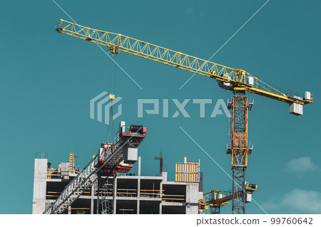 Amazing Bright Blue Clear Sky Above Construction Crane. Construction And Development Of New Multi-storey Residential Building. Conception Of Development. New Accommodation Amazing Bright Blue Clear Sky Above Construction Crane. Construction And Development Of New Multi-storey Residential Building. Conception Of Development. New Accommodation 99760642