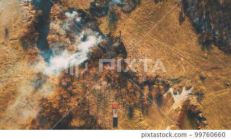 firefighters extinguish burning grass with hoses Aerial View. Sp firefighters extinguish burning grass with hoses Aerial View. Sp 99760660