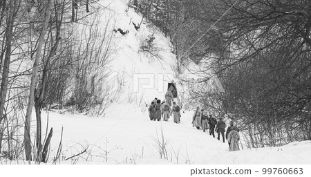 Men Dressed As White Guard Soldiers Of Imperial Russian Army In Russian Civil War s Marching Through Snowy Winter Forest. Historical Reenactment 99760663