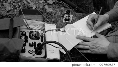 Infantry Army Soldier In World War II using Portable Radio Transceiver In Trench Entrenchment In Forest. . Headphones And Telegraph Key. Close Up Hands, Black And White Colors 99760687