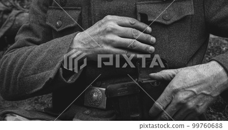 World War II German Soldier Cleaning Rifle. Soldier Preparing We 99760688