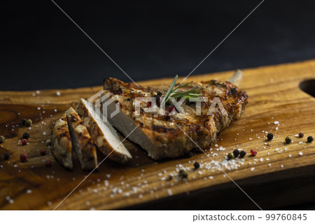 pork cutlet with a bone on rosemary and pepper 99760845