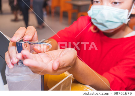 Asian young girl using alcohol antiseptic gel and wearing prevention mask, prevent against infection of Covid-19 outbreak, girl washing hands with hand sanitizer to avoid contaminating with Coronaviru Asian young girl using alcohol antiseptic gel and wearing prevention mask, prevent against infection of Covid-19 outbreak, girl washing hands with hand sanitizer to avoid contaminating with Coronaviru 99761679