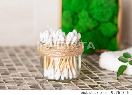 bamboo cotton swabs in glass jar on the bathroom counter. 99761856