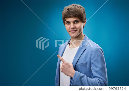 young man in jacket pointing at copy space young man in jacket pointing at copy space 99763514