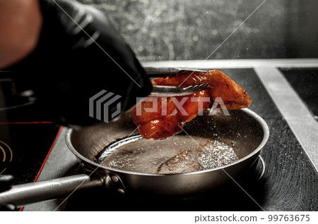 cooking delicious food in the kitchen with the addition of spices 99763675