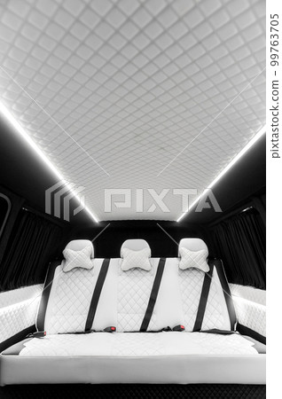 Comfortable interior of a passenger bus with soft seats Comfortable interior of a passenger bus with soft seats 99763705