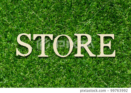Wood letter in word store on green grass background Wood letter in word store on green grass background 99763992