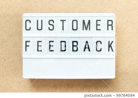 Lightbox with word customer feedback on wood background 99764094