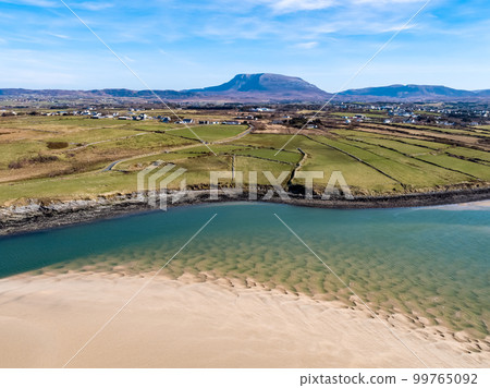 Aerial view of Ballyness Bay and Magheraroarty with the Muckish in the background in County Donegal - Ireland Aerial view of Ballyness Bay and Magheraroarty with the Muckish in the background in County Donegal - Ireland 99765092