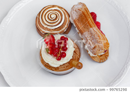 Rum baba lemon tart and Chantilly eclair Rum baba lemon tart and Chantilly eclair 99765298