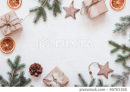 Neutral Christmas frame of fir branches, eco friendly gifts and baubles Cutout 99765308